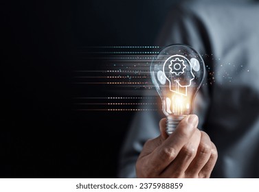 Hand man holding illuminated lightbulb, idea, innovation and inspiration with glowing virtual brain, smart intelligent creativity with bulbs, Motivation and innovation concept. - Powered by Shutterstock