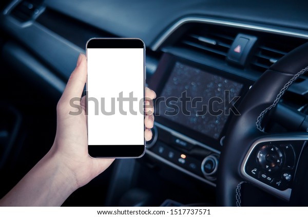 hand man\
holding use smartphone new model, For searching for directions,\
travel, in the latest car models.Concept of using a car phone For\
convenience and reduce accidents.blank\
screen