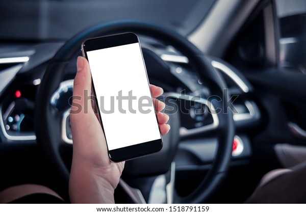 hand man\
holding use smartphone new model, For searching for directions,\
travel, in the latest car models.Concept of using a car phone For\
convenience and reduce accidents.blank\
screen