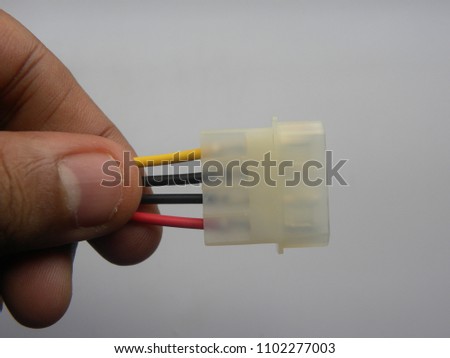 Hand of man holding white color 4 pins hard drive connector cable on white background