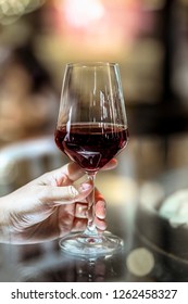 Hand Of Man Holding A Wine Glass In The Bar.