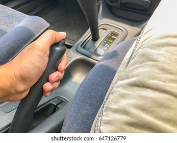 hand of man on hand break in car