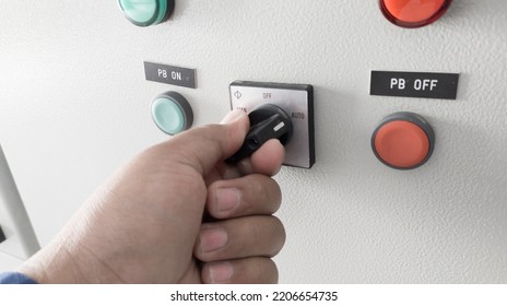 The hand man operating selector switch to control. - Shutterstock ID 2206654735