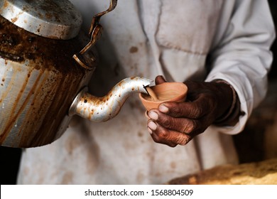 Hand Of A Man Pouring Indian Traditional Hot Tea On Clay Pot. Indian Clay Tea.