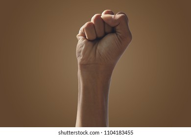 hand Man raised fist air fighting - Shutterstock ID 1104183455