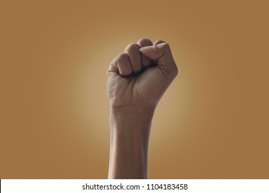hand Man raised fist air fighting - Shutterstock ID 1104183458