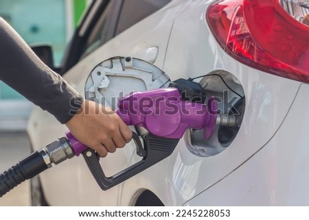 Hand Man Refill and filling Oil Gas Fuel at station.Gun petrol in the tank to fill.Fuel pump at station.Refueling automobile with gasoline or diesel with a fuel dispenser.