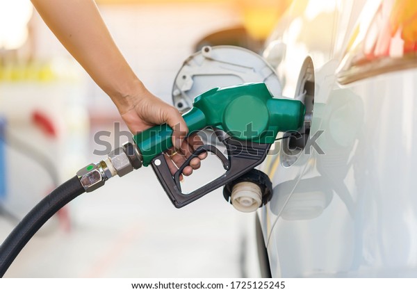 Hand Man Refill and\
filling Oil Gas Fuel at station. Gas station - refueling. To fill\
the machine with fuel. Car fill with gasoline at a gas station. Gas\
station pump. 