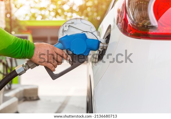 Hand Man Refill and\
filling Oil Gas Fuel at station. Gas station - refueling. To fill\
the machine with fuel. Car fill with gasoline at a gas station. Gas\
station pump.