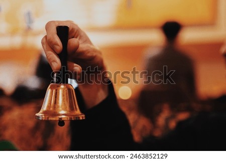 Hand of a man ringing a handbell