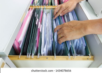 Hand Of Man Search Files Document In A File Cabinet In Work Office, Concept Business Office Life.