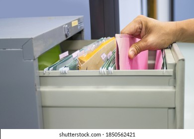 Hand Of Man Search Files Document In A File Cabinet In Work Office, Concept Business Office Life.