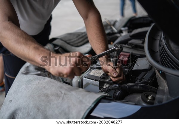 Hand of man with
tool, shop Service center, car repair, tire change. Mechanic
changing engine, service car workshop automobile. professional man
shop maintenance	