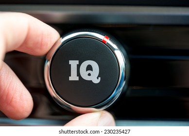 Hand Of A Man Turning Up A Dial With The Word IQ Depicting Increasing Ones Intelligence Quotient.