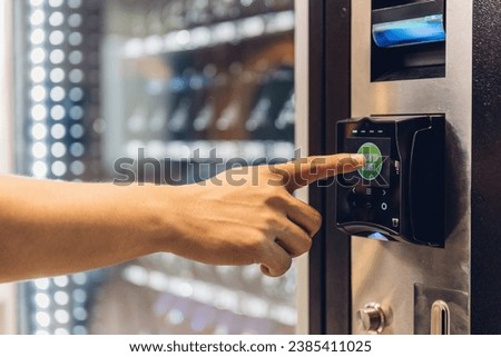 Hand man use of soft drink vending system. Man use drink coin machine at smart office or Public park. People use  Vending Machine, is robotic for the high-quality drink 