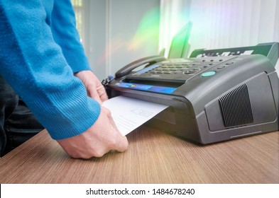 hand man are using a fax machine in the office Business concept