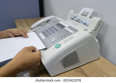 hand man are using a fax machine in the office, equipment for data transmission.