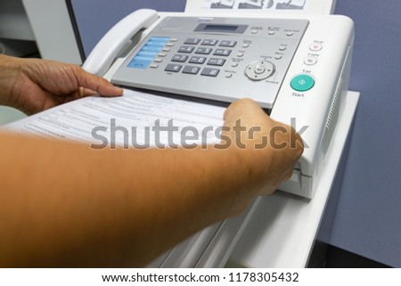 Hand man are using a fax machine in the office, Business concept information.