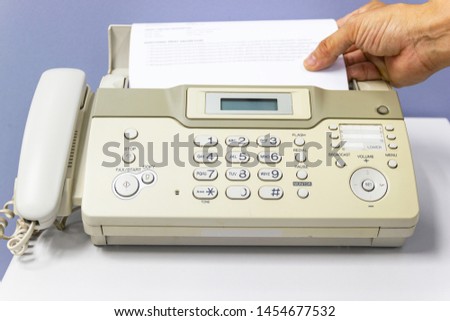 hand man are using a fax machine in the office Business concept 