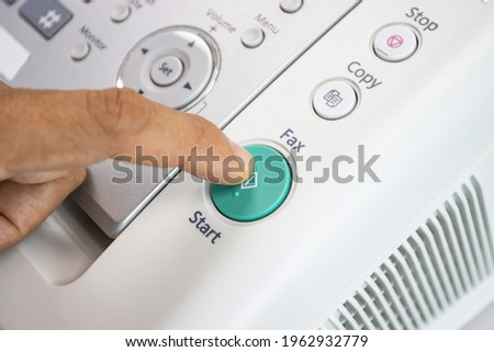 hand man are using a fax machine in the office, equipment for data transmission.