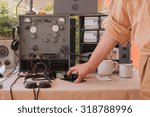 A hand of a man using a World War telegraph.