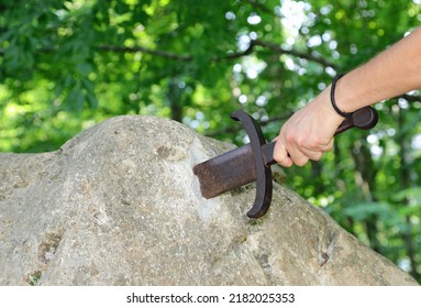 Hand Of The Man Who Tends To Perform The Legendary Feat Of Extracting The Sword Stuck In The Rock In The Middle Of The Forest Of Trees