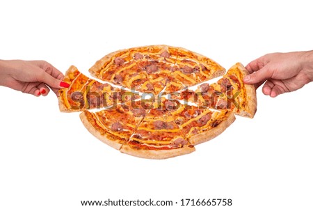 A hand of a man and a woman take slices of pizza, angle view. Tasty pizza with beef sausages, mozzarella, various sauces and marinated red onions, isolated on white background