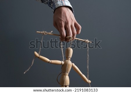 hand manipulate threaded puppet marionette, human manager master