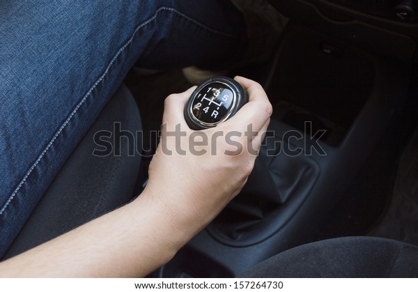 hand with manual\
gear shift lever close up