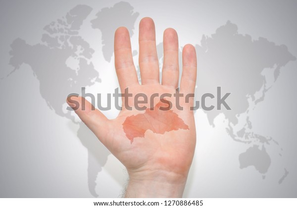 hand with map of central african\
republic on the gray world map background.\
concept