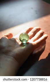 Hand and a marble