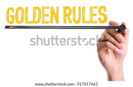 Hand with marker writing: Golden Rules