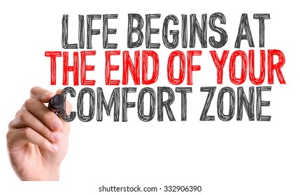 Hand with marker writing: Life Begins At The End of Your Comfort Zone 
