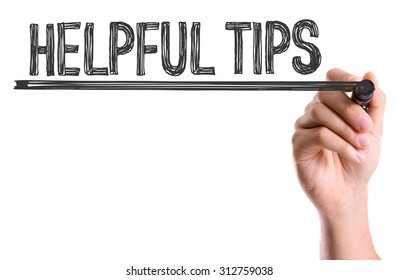 Hand with marker writing the word Helpful Tips