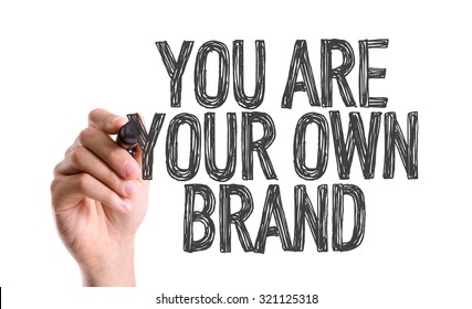 Hand with marker writing: You Are Your Own Brand