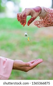 A Hand Of Married Couple With Wedding Ring Floating On Air. Selective Focus 