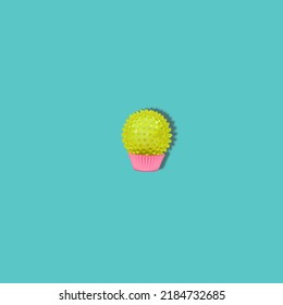 A hand massage ball creates a funny cupcake. Concept with a minimal design.