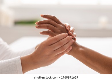 Hand Massage. Female Therapist Pressing Specific Spots On Black Lady Palm. Professional Health And Wellness Acupressure Manipulations, Closeup