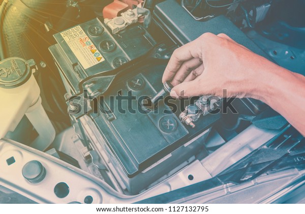 Hand mechanic in repairing car and check the engine\
daily before use, 