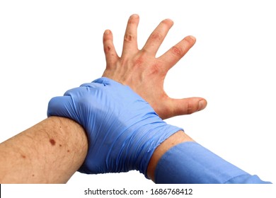 A Hand In A Medical Glove Holds The Hand Of A Violent Patient On A White Background, Isolated. Protection Concept