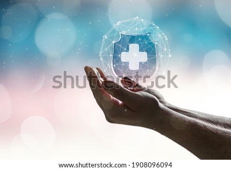Hand with medical sign on blur background. Medical care insurance