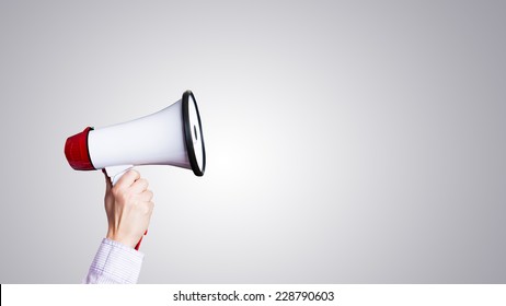 hand with megaphone - Shutterstock ID 228790603