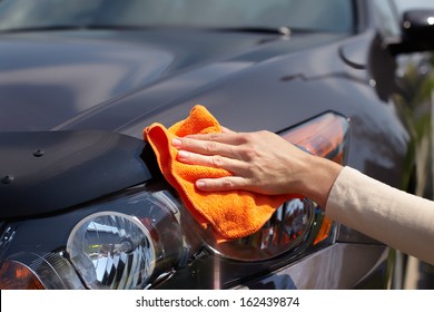 Hand With Microfiber Cloth Cleaning Car.