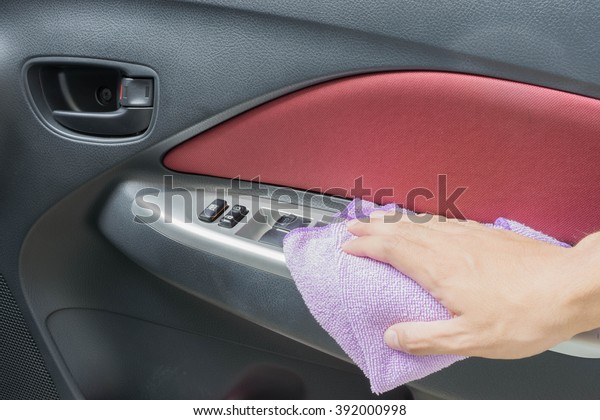 Hand with\
microfiber cloth cleaning\
car.\
