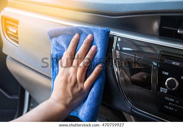 Hand\
with microfiber cloth cleaning Interior modern\
car.