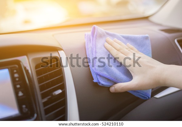Hand with microfiber cloth cleaning leather\
seat,auto detailing and valeting concept,washing car care\
interior,selective focus,vintage\
color\

