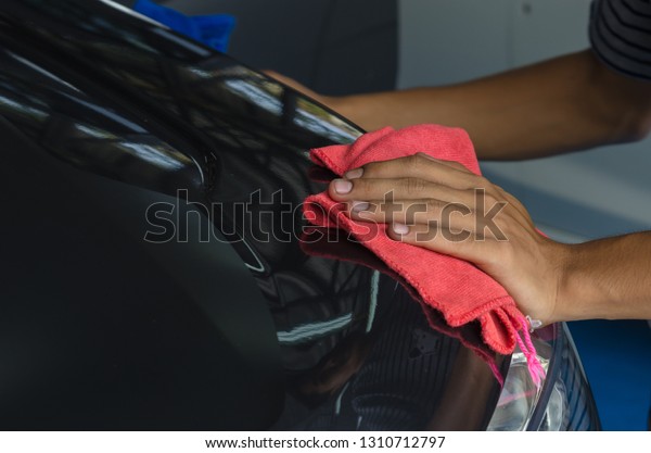 Hand with\
microfiber cloth, wipe the car\
clean