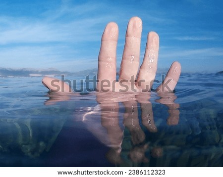 Hand Of Middle Aged Woman Out Of The Sea Water. Swimming In The Sea. View From Below. Nature Surface. 