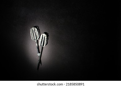 Hand Mixer Beaters Used For Whisking White Cream Cheese Filling Against Black Background. Dark Cooking Aesthetic. Process Of Making Birthday Cheesecake.