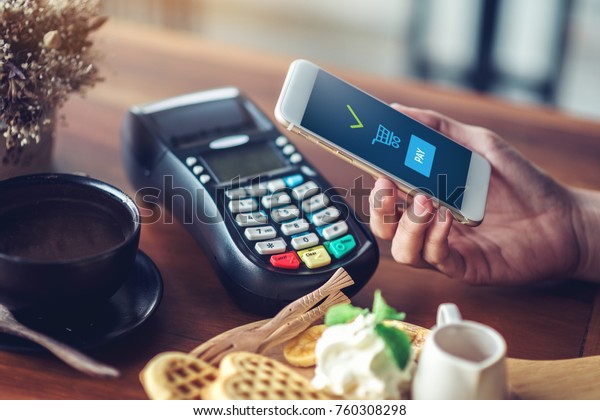 Hand and mobile payment in coffee shop ,mobile\
payment concept